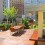 A custom built rooftop deck in New York City. Wood decking with planters, custom furniture and tree planters